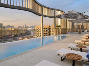 a swimming pool on the roof of a building at Mercure Dubai Deira in Dubai