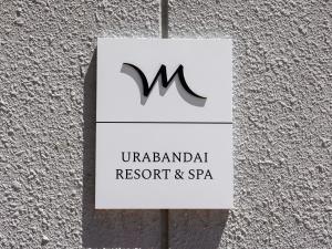 a sign for a restaurant and spa on a wall at Mercure Urabandai Resort & Spa in Kitashiobara