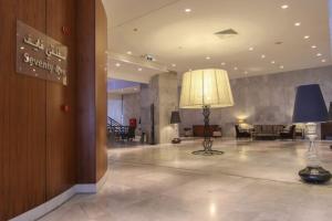 a lobby with a lamp in the middle of a building at A urassi an HTT hotel in Isly