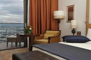 a bedroom with a bed and a view of a city at A urassi an HTT hotel in Isly