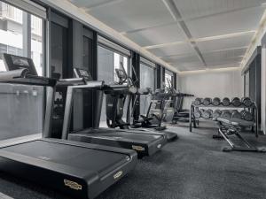 a gym with rows of treadmills and machines at Mercure ICON Singapore City Centre in Singapore