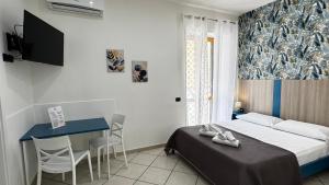 a bedroom with a bed and a table and a desk at Villa Flora in Pompei