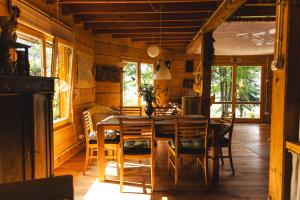 a dining room with a wooden table and chairs at Bukowica Miła - Dom z sauną w sercu Natury 2000 in Wola Piotrowa