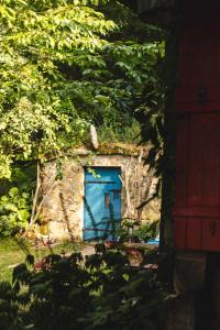 a blue door in the side of a stone building at Bukowica Miła - Dom z sauną w sercu Natury 2000 in Wola Piotrowa