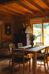 a dining room with a wooden table and chairs at Bukowica Miła - Dom z sauną w sercu Natury 2000 in Wola Piotrowa +62 photos