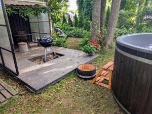 a backyard deck with a grill and a hot tub at Kaberneeme Puhkemaja - Kaberneeme Holiday Home in Kaberneeme