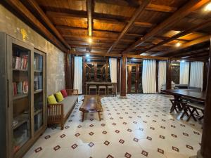 a living room with a piano and a table at Núi Dinh Stilt House - Phú Mỹ in Ấp Long Cát