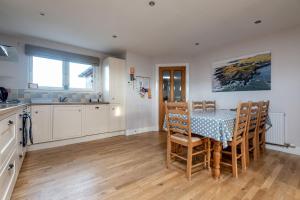 a kitchen and dining room with a table and chairs at Craiglea - Elie & Earlsferry in Earlsferry