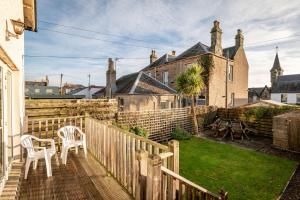 a balcony with a table and chairs on a house at Craiglea - Elie & Earlsferry in Earlsferry