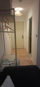 a room with a bunk bed and a hallway at À la brise marine in Saint-Benoît