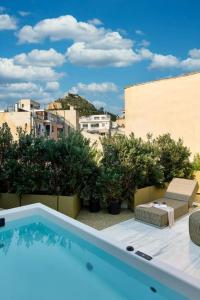 a swimming pool on top of a building at The Newel Kolonaki in Athens