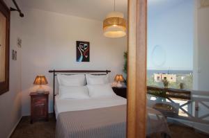 a bedroom with a bed and a window with a view at Villa Kyma in Aegina +74 photos