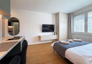 a bedroom with a bed and a sink and a mirror at Cozy Emerald Studio Bratislava in Bratislava