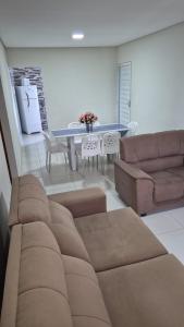 a living room with a couch and a table at Apartamento Maragogi Peroba in Maragogi