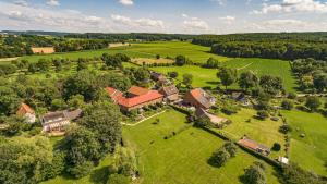 an aerial view of a large house on a green field at Ruim sfeervol appartement naast wijndomein in Vijlen, Zuid-Limburg in Vijlen