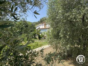 a view of a house through the trees at Ribelles in Eus +9 photos