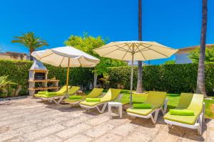 a group of chairs and umbrellas on a patio at Estrel in Can Picafort