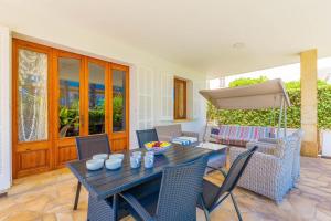 a dining room with a table and chairs and an umbrella at Estrel in Can Picafort