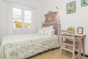 a bedroom with a bed and a chair and a window at Construcciones Balaguer in Mancor del Valle +37 photos