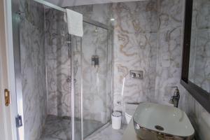 a bathroom with a shower with a toilet and a sink at Siete Hotel in Antalya +30 photos