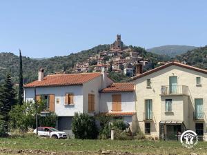 a white house with a hill in the background at Mas garrigole in Eus +5 photos