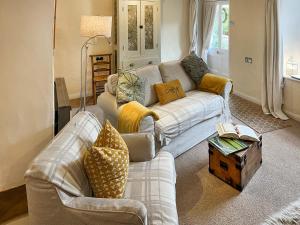 a living room with a couch and a table at Lock Heather Cottage in Reeth