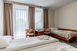 a hotel room with two beds and a window at LUNA Baltica in Rewal +74 photos