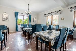 a dining room with tables and blue chairs at LUNA Baltica in Rewal