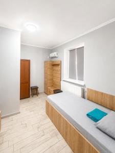 a bedroom with a large bed and a wooden floor at Hotel Dulgher in Giurgiuleşti