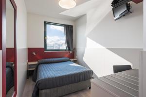 Voodi või voodid majutusasutuse Hotel Porta Palio toas