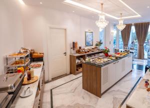 a buffet in a restaurant with a lot of food at Hotel Oasis in Sarandë