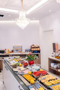 a buffet of food on a counter in a kitchen at Hotel Oasis in Sarandë