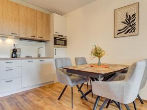 a kitchen with a table and chairs in a room at Apartment Kapina in Pamporovo