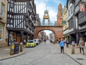 a city street with a bridge and a clock tower at Weetwood Lodge in Kelsall
