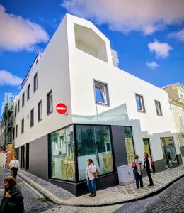 a group of people standing outside of a building at Apartamento Sonho Mar in Ponta Delgada