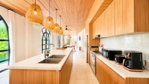 a kitchen with a sink and a counter top at 4Bedroom Umah Jeng Alessia Villa - Pererenan by SooBali in Munggu