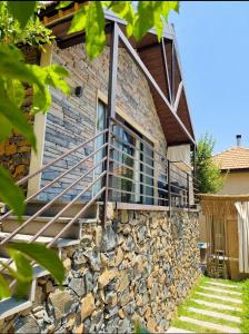 a stone house with a staircase on the side of it at Amarillis lb 