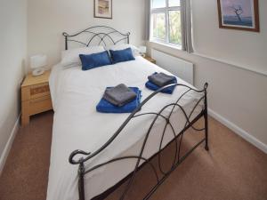 a bedroom with a bed with two towels on it at Station House in St Bees