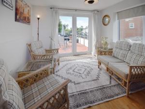 a living room with a couch and chairs and a window at Station House in St Bees +7 photos