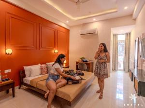 two women standing in a hotel room with a bed at Zostel Jaipur in Jaipur