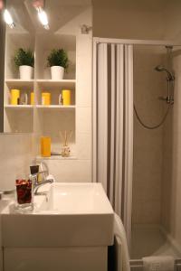 a white bathroom with a sink and a shower at Dimora delle Arti in Naples