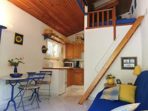 a kitchen with a staircase and a table and chairs at Les lauriers in Sahorre