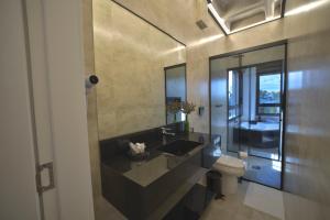 a bathroom with a sink and a toilet at Pousada Premium Terragnolo in Bento Gonçalves +51 photos