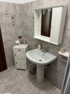 a bathroom with a sink and a mirror at Casa Vacanze ai Valentini in Castelletto Soprano