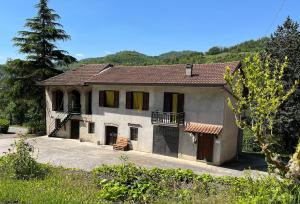 a large white house with a porch and a balcony at Casa Vacanze ai Valentini in Castelletto Soprano