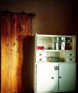 a kitchen with a white refrigerator and a wooden wall at Kamiare in San Esteban +1 photo