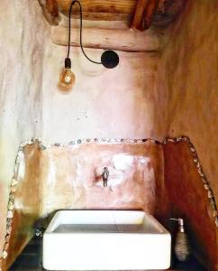 a bathroom with a white sink in a room at Kamiare in San Esteban