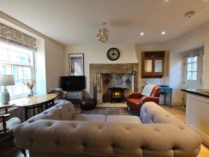 a living room with a couch and a fireplace at Eden's House in Hexham