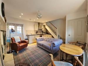a living room with a couch and a table at Eden's House in Hexham