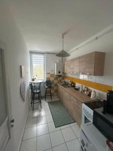 a kitchen with a table and chairs in a room at Digitális Detox Apartman in Tiszafüred